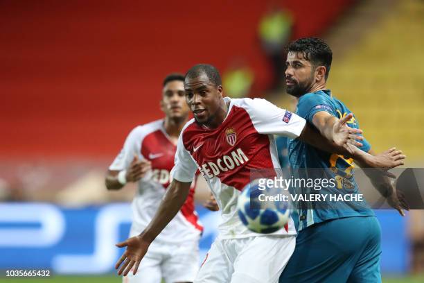 Monaco's French defender Djibril Sidibe eyes the ball as he vies for it with Atletico Madrid's Spanish forward Diego Costa during the UEFA Champions...