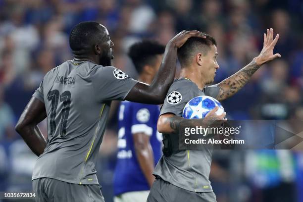 Otavio of FC Porto celebrates with Moussa Marega of FC Porto after he scores his sides first goal from the penalty spot during the Group D match of...