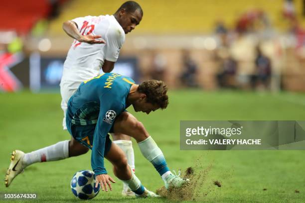Monaco's French defender Djibril Sidibe vies for the ball with Atletico Madrid's French forward Antoine Griezmann during the UEFA Champions League...
