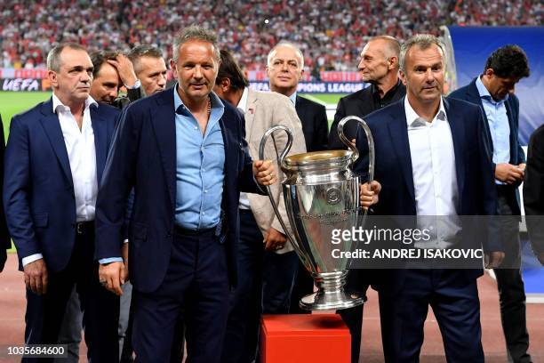 Former Serbian football stars Sinisa Mihajlovic and Dejan Savicevic pose with a replica of the Champions League trophy that Red Star Belgrade won in...