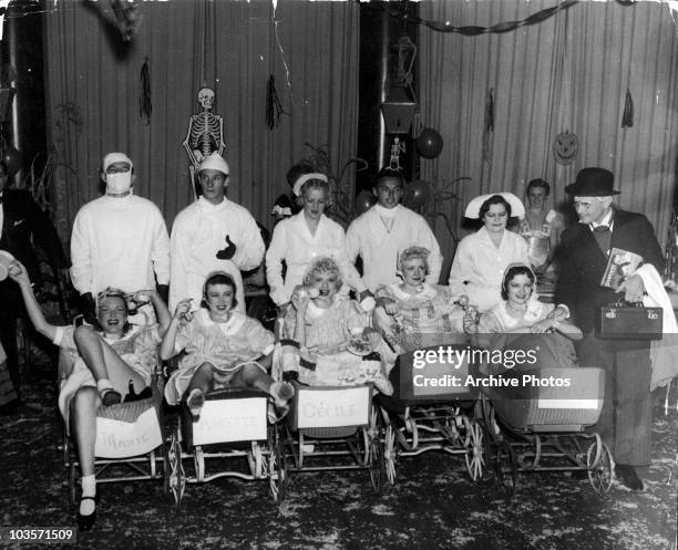 American actress Lucille Ball dressed as a baby at the Quints-Coogan party, November 1935. She and four other women are dressed as the Dionne...