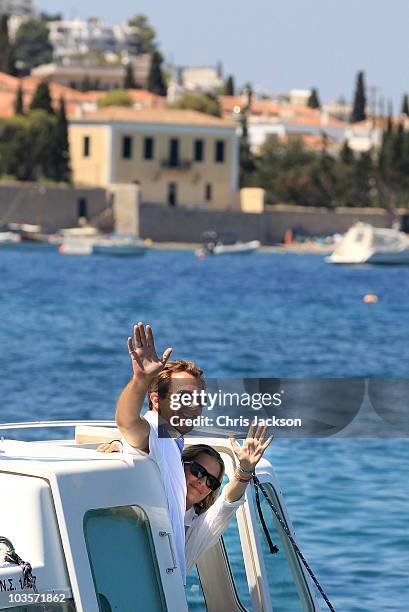 Prince Nikolaos and his fiance Tatiana Blatnik wave from a boat as they depart the Poseidon Hotel on the island of Spetses on August 24, 2010 in...