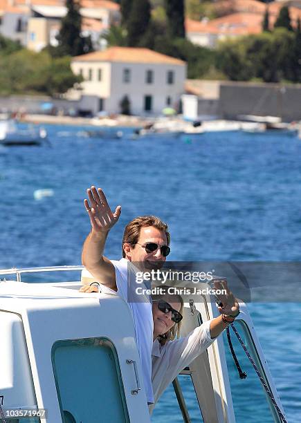 Prince Nikolaos and his fiance Tatiana Blatnik wave from a boat as they depart the Poseidon Hotel on the island of Spetses on August 24, 2010 in...