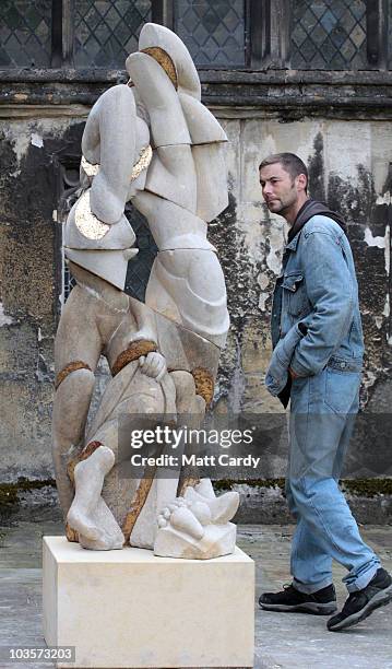 People pass sculptures in Gloucester Cathedral as sculptures begin to arrive for the Crucible Exhibition on August 24, 2010 in Gloucester, England....