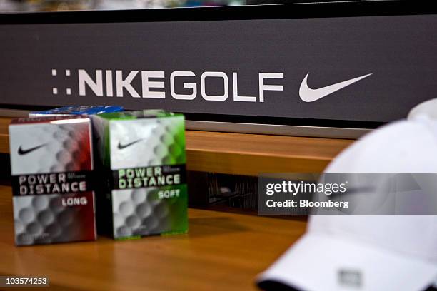 Nike brand golf balls and apparel sit on display at a Golfsmith retail store in New York, U.S., on Thursday, Aug. 19, 2010. Golfer Tiger Woods has...