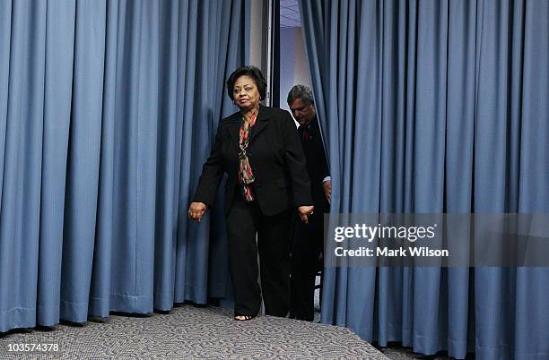 Shirley Sherrod , a former USDA official, and Agriculture Secretary Tom Vilsack walk into a news conference after a meeting at the Department of...