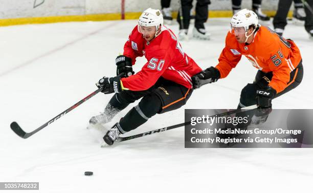 Left center Benoit-Olivier Groulx and right winger Kiefer Sherwood of the Anaheim Ducks race for the puck during the Anaheim Ducks Rookie Camp at...