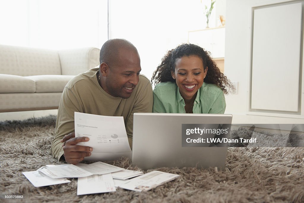 Couple in livingroom paying bills