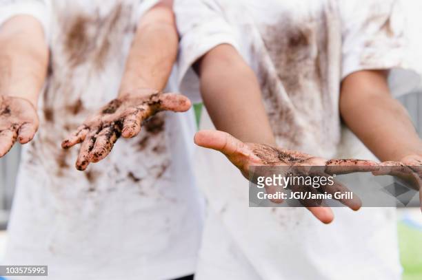 boys displaying their messy hands - macchie di colore foto e immagini stock