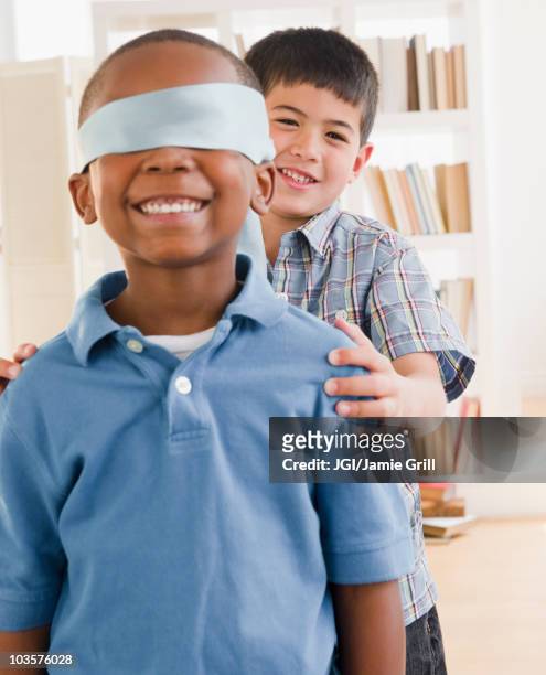 boy spinning friend wearing blindfold - blind fold stock pictures, royalty-free photos & images