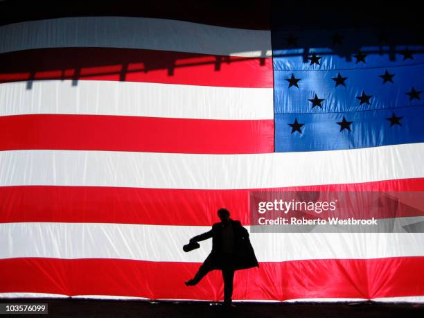 silhouette of man behind american flag - american flag on stage stock pictures, royalty-free photos & images