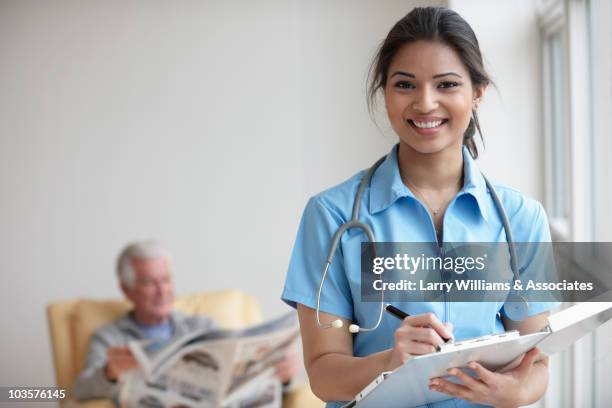 mixed race nurse caring for patient - clinic canada diversity stock-fotos und bilder