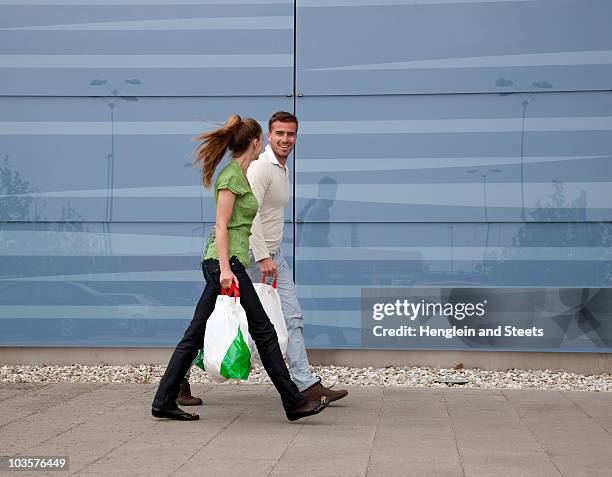 couple shopping - side view carrying stock pictures, royalty-free photos & images