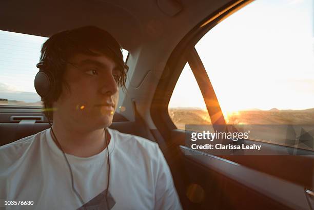boy traveling in back seat of car - teenage boy looking out window stock pictures, royalty-free photos & images