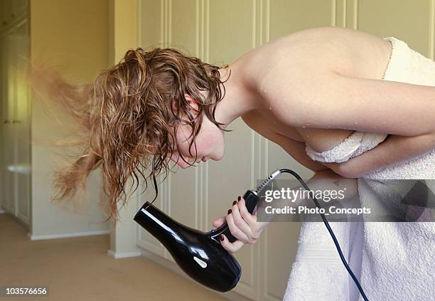 young woman drying hair - hair dryer stock pictures, royalty-free photos & images
