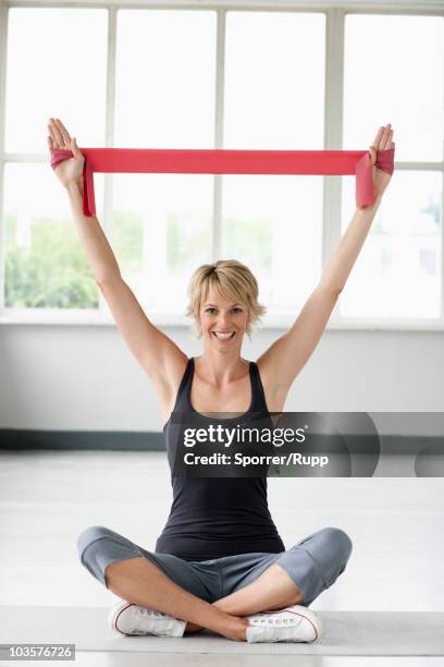 woman exercising with resistance band - elastiekje stockfoto's en -beelden