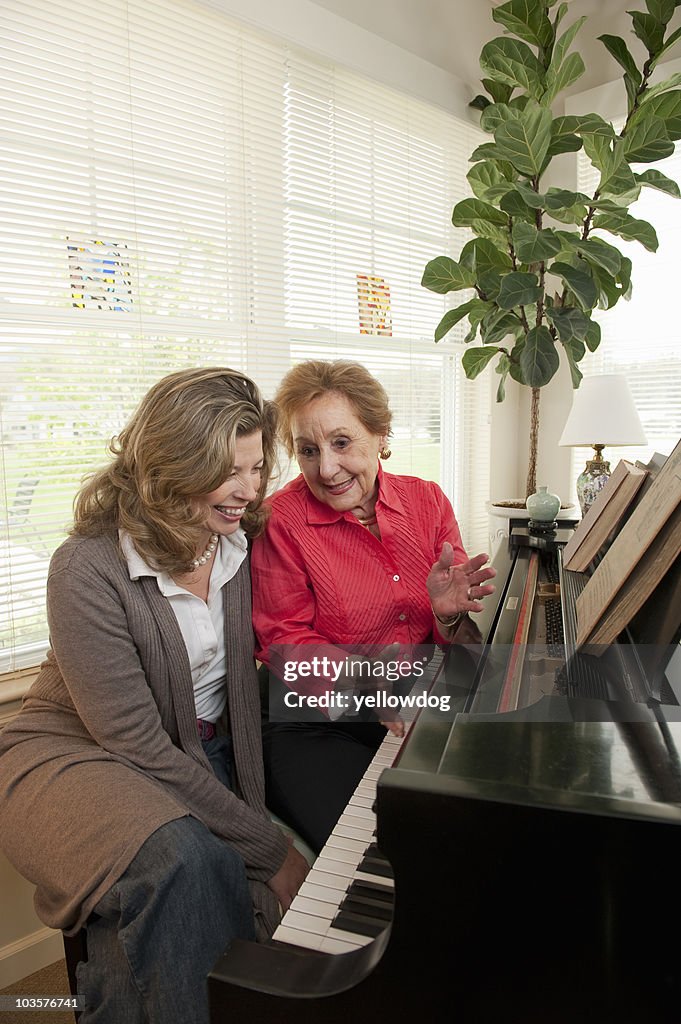 Mother and daughter talking at piano