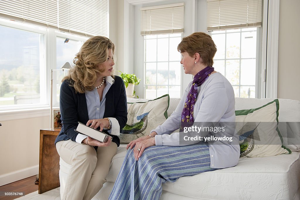 Mother and daughter talking couch