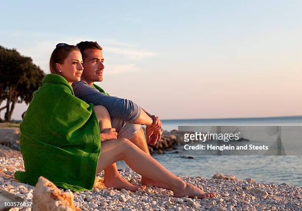 couple sitting at beach - croatia coast stockfoto's en -beelden