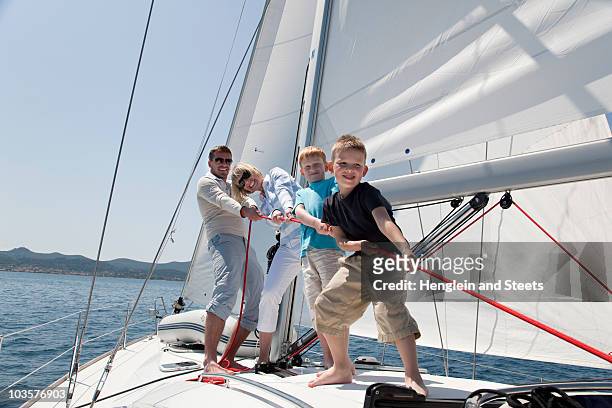 family pulling rope on yacht - kid sailing imagens e fotografias de stock