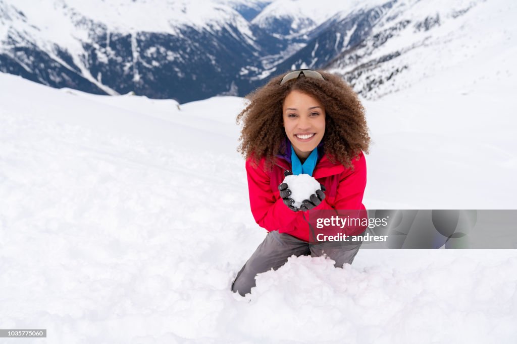 Playful woman having fun in a snowball fight