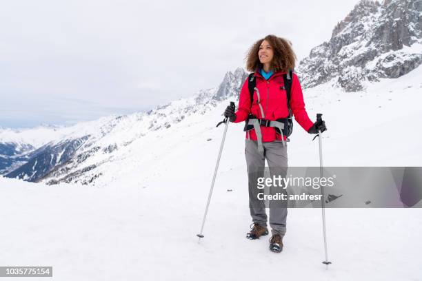 thoughtful woman trekking in the snow mountains - person of colour stock pictures, royalty-free photos & images