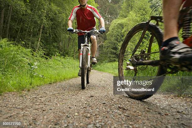 two cyclists on track in countryside - pebbled road stock pictures, royalty-free photos & images