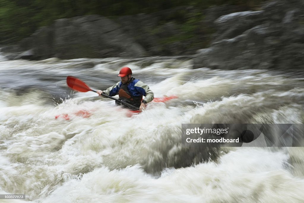 Man kayaking in river