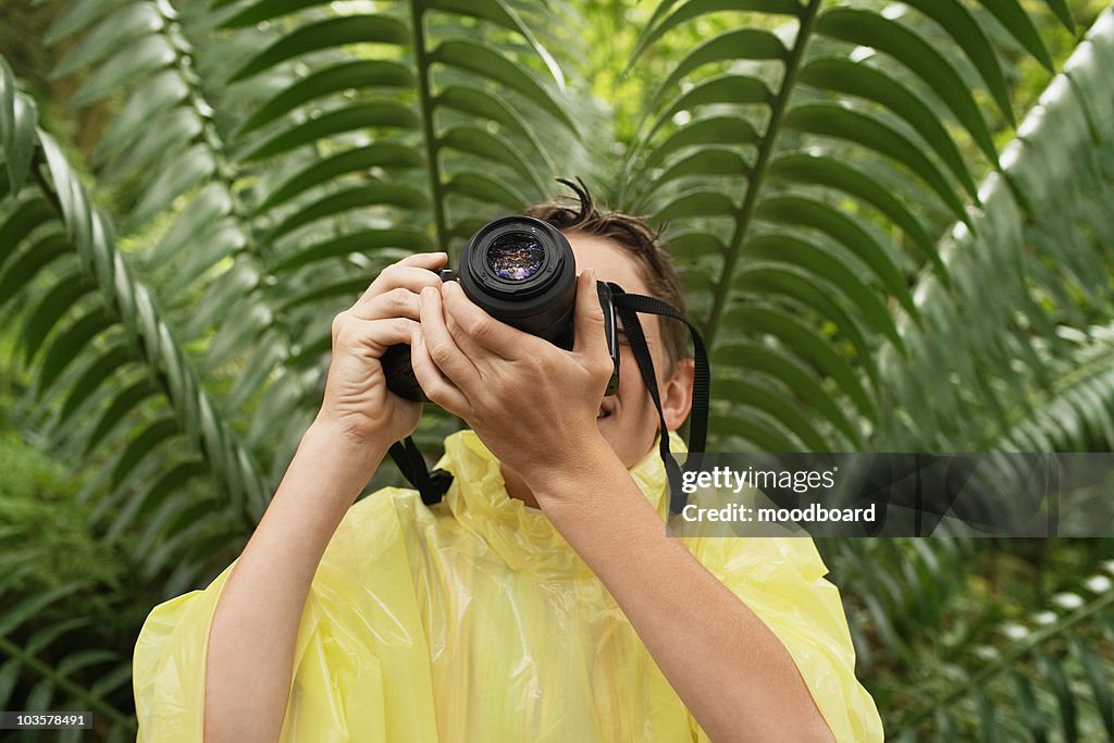 Boy Taking Photos in Forest