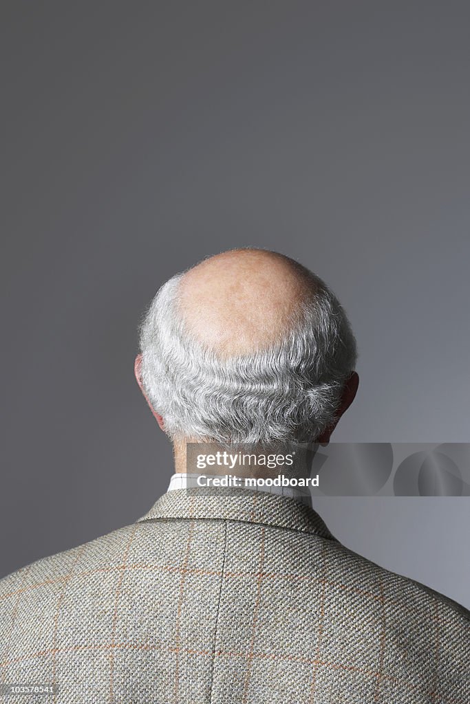 Senior Man in studio, head and shoulders, back view