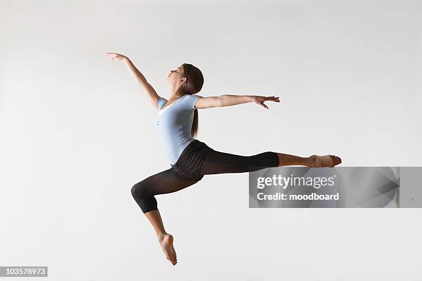 ballerina leaping in mid-air - ballet black and white stock pictures, royalty-free photos & images