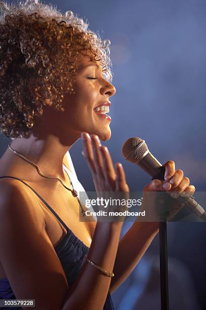 jazz singer on stage, side view - boygroup stock-fotos und bilder