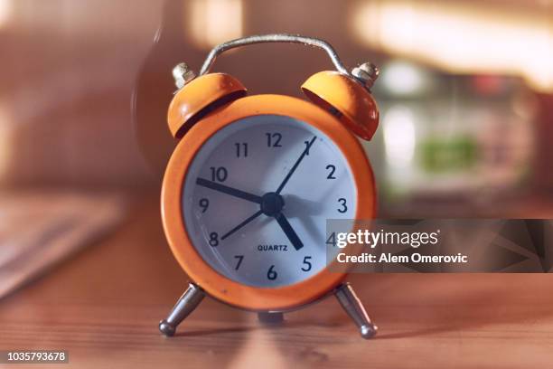 small orange watch on the shelves in living room - orange alarm clock stock pictures, royalty-free photos & images