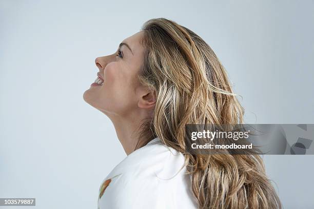 profile of young woman smiling - looking over his shoulder stockfoto's en -beelden