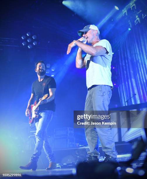 Matthew Ramsey of Old Dominion and Kenny Chesney perform at the Ryman Auditorium on September 18, 2018 in Nashville, Tennessee.