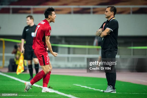 Wu Lei of Shanghai SIPG celebrates a goal before Fabio Cannavaro of Guangzhou Evergrande Taobao during the 2018 Chinese Super League match between...