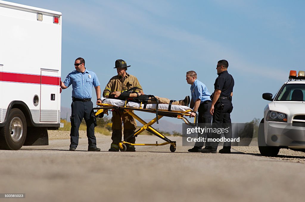 Paramedics transporting victim on stretcher