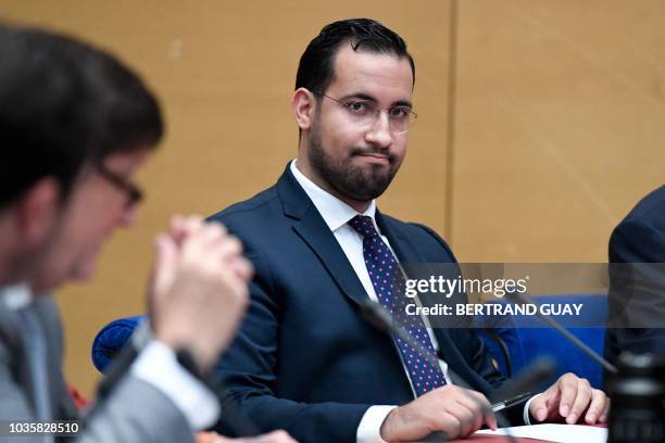 Former Elysee senior security officer Alexandre Benalla looks over prior to the start a Senate committee in Paris on September 19, 2018. The...