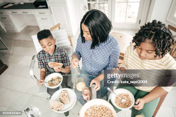 healthy choices for kids breakfast - boy eating cereal stock pictures, royalty-free photos & images