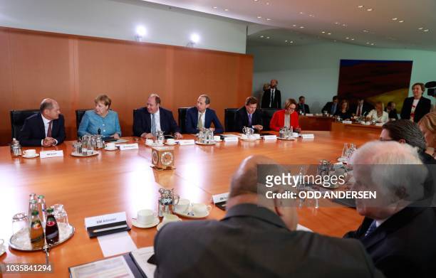 German Interior Minister Horst Seehofer talks with German Economy Minister Peter Altmaier as German Chancellor Angela Merkel prepares to lead the...