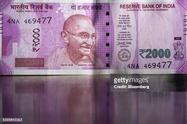 The portrait of Mahatma Gandhi is displayed on an Indian 2,000 rupee banknote in an arranged photograph in Bangkok, Thailand, on Wednesday, Sept. 12,...