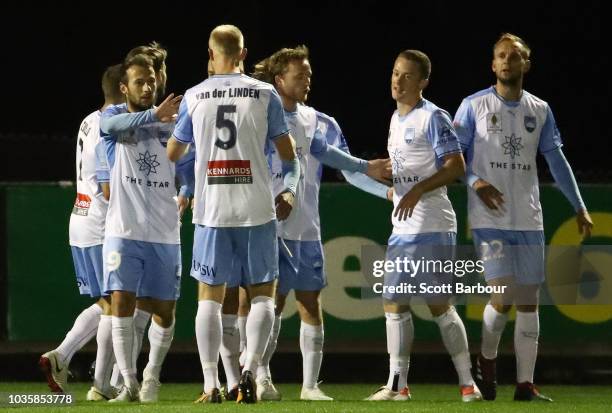 Trent Buhagiar is congratulated by Adam Le Fondre and Siem de Jong after scoring the first goal during the FFA Cup quarterfinal match between...