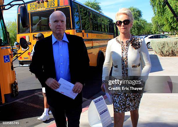 Sen. John McCain and his wife Cindy McCain arrive at Madison Camelview Elementary School to cast their ballots in Arizona's primary election August...