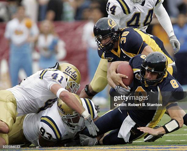 Cal's quarterback Aaron Rodgers is tackled in the third quarter as California defeated UCLA 45 to 28 at Memorial Stadium, University of California,...