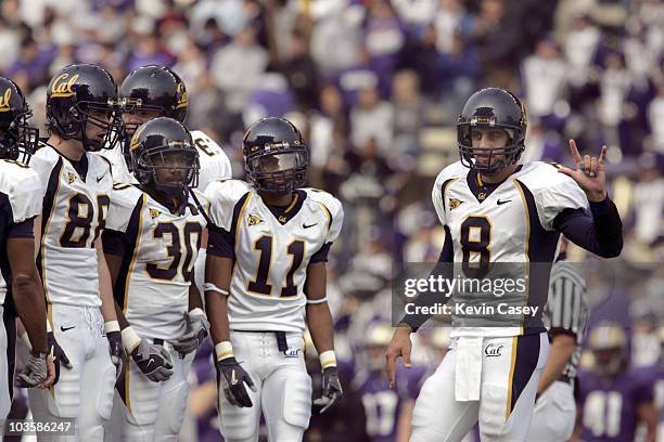 California Golden Bears quarterback Aaron Rodgers right, gets a play signal at the huddle during the game at Husky Stadium in Seattle on Saturday...