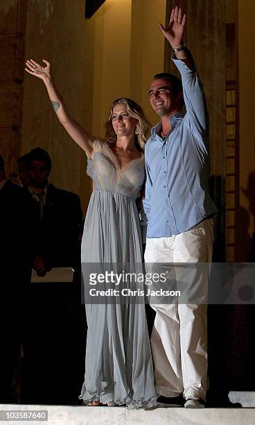 Prince Nikolaos and his fiance Tatiana Blatnik wave from the Poseidon Hotel as they attend their pre-wedding reception on August 24, 2010 in Spetses,...