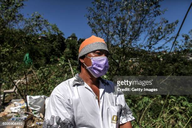Joel Vicente waits for the body of his nephew, William Sigang, who is a miner and a victim of the landslide on September 19, 2018 in Itogon, Benguet...