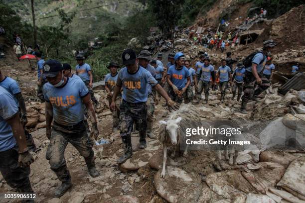 Filipino rescuers dig at the site where people were believed to have been buried by a landslide on September 19, 2018 in Itogon, Benguet province,...
