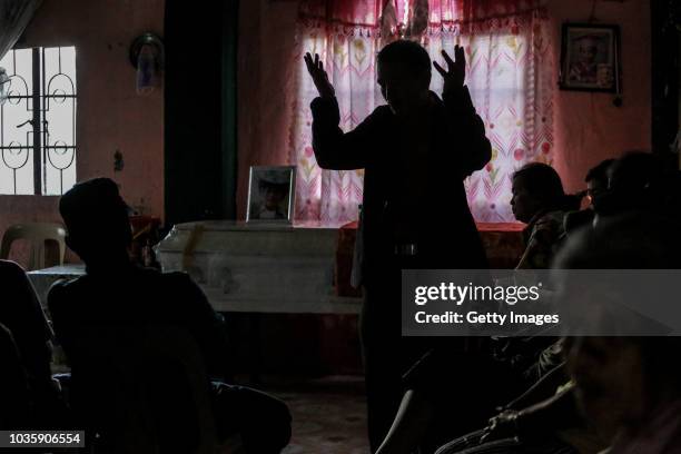 Pastor prays over the coffin of Andrew Tagapong, one of the miners killed by a landslide on September 19, 2018 in Itogon, Benguet province,...