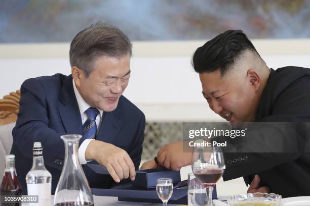 South Korean President Moon Jae-in talks with North Korean leader Kim Jong Un during a lunch at the Okryugwan restaurant on September 19, 2018 in...